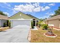 Inviting single-story home boasting a well-manicured lawn and charming decorative wishing well feature at 108 Orion Way, Sanford, FL 32773