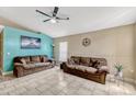 Bright living room featuring tile floors, vaulted ceiling with fan, and comfortable seating at 108 Orion Way, Sanford, FL 32773