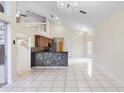 Open-concept living room featuring tile floors, a mosaic wet-bar, and an elegant chandelier at 12543 Waterhaven Cir, Orlando, FL 32828