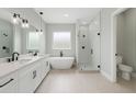 Modern bathroom with a double vanity, soaking tub, glass-enclosed shower, and sleek fixtures at 13254 Sw 30Th Terrace Rd, Ocala, FL 34473