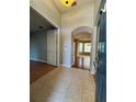Inviting foyer with tile flooring, arched doorway, and neutral paint at 1432 Stargazer Ter, Sanford, FL 32771