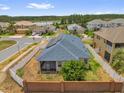Aerial view of a home with a fenced backyard, screened porch, and solar panels at 16780 Meadows St, Clermont, FL 34714