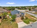Corner lot home featuring a brick driveway and well-maintained landscaping at 16780 Meadows St, Clermont, FL 34714