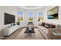 Inviting living room features a neutral color palette, a comfortable seating arrangement, and abundant natural light at 16780 Meadows St, Clermont, FL 34714