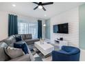 Spacious living room featuring a comfortable gray couch, modern decor, and lots of natural light at 1820 Summer Dr, Davenport, FL 33897
