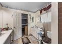 Functional bathroom featuring a single vanity, neutral tile, and doorway to a bedroom at 2213 Bates Ave, Eustis, FL 32726