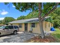 Side view of home, showcasing the driveway, mature tree, and a comfortable facade at 2213 Bates Ave, Eustis, FL 32726