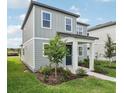 Charming two-story home with gray siding, well-manicured landscaping, and inviting front entrance at 2467 Zuni Road, St Cloud, FL 34771