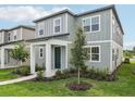 Charming two-story home with gray siding, well-manicured landscaping, and inviting front entrance at 2467 Zuni Road, St Cloud, FL 34771