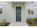 Inviting front door with white trim, modern house number, and neatly landscaped surroundings at 2467 Zuni Road, St Cloud, FL 34771