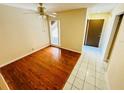 The bedroom has hardwood floors and a ceiling fan along with a door to the outside at 248 Crown Oaks Way, Longwood, FL 32779
