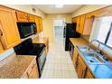 A kitchen with appliances and beautiful granite countertops has been updated for modern living at 248 Crown Oaks Way, Longwood, FL 32779