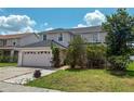 Inviting two-story home with lush landscaping, well-maintained lawn, and attached two-car garage at 2530 Baykal Dr, Kissimmee, FL 34746