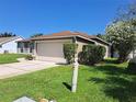 Well-manicured lawn and landscaping accent this single Gathering home with a two car garage at 2863 Middleton Cir, Kissimmee, FL 34743