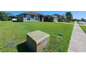 View of neighborhood house with a well-maintained lawn and landscaping at 2863 Middleton Cir, Kissimmee, FL 34743