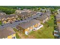 Aerial view of townhome community with dedicated parking and well-maintained landscaping at 318 Australian Way, Davenport, FL 33897