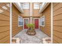Townhome courtyard featuring matching red doors and a neatly maintained landscape at 318 Australian Way, Davenport, FL 33897