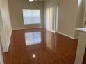 Open-concept living room with lustrous brown tile floor, a ceiling fan and sliding glass doors at 4001 San Sabastian Dr # 107 Of 51, Kissimmee, FL 34741