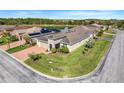 An aerial view of a single Gathering home showing a lake and several solar panels in the neighborhood at 428 Bel Air Way, Kissimmee, FL 34759