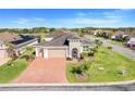 An aerial view of a house with a brick driveway, two car garage and landscaping at 428 Bel Air Way, Kissimmee, FL 34759