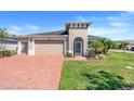 Charming home featuring a two-car garage, brick driveway, and a neatly landscaped front yard at 428 Bel Air Way, Kissimmee, FL 34759