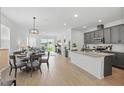 Open-concept area featuring a dining space, granite-counter kitchen and backyard patio access at 4338 Davos Dr, Clermont, FL 34711