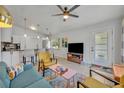 Bright and airy living room featuring modern decor, tile flooring, and seamlessly integrated with the kitchen at 440 E Crystal Lake St, Orlando, FL 32806