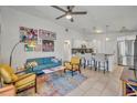 Open concept living room flows into the kitchen with white cabinets and stainless steel appliances at 440 E Crystal Lake St, Orlando, FL 32806