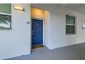 Welcoming entryway featuring a blue front door with sidelight windows and a cozy mat at 4731 Clock Tower Dr # 104, Kissimmee, FL 34746