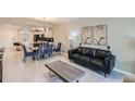 Open-concept living area with modern furnishings, artwork, and a dining area at 4731 Clock Tower Dr # 104, Kissimmee, FL 34746