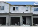 Unfinished townhouse exterior featuring garage and windows at 5099 Prairie Preserve Run, St Cloud, FL 34772