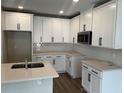 Modern kitchen with white cabinets, stainless steel appliances, and quartz countertops at 5103 Prairie Preserve Run, St Cloud, FL 34772