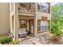 Charming home exterior with a cozy front porch and quaint seating area at 5452 E Michigan St # 7, Orlando, FL 32812