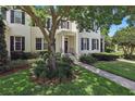 Charming two-story home with a landscaped front yard and inviting entrance, enhanced by a mature tree at 5489 Baldwin Park St, Orlando, FL 32814