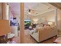 Relaxing living room with neutral color palette, tile flooring, ceiling fan, and a stylish fish tank feature at 5489 Baldwin Park St, Orlando, FL 32814