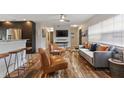 Open-concept living area featuring wood flooring, comfortable seating, and a kitchen bar at 550 Birch Ct, Altamonte Springs, FL 32714