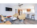 Open-concept living area with modern furniture, sleek kitchen, and inviting breakfast bar seating at 631 Trailwood Dr, Altamonte Springs, FL 32714