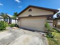 A two-car garage with ample parking space and a neatly paved driveway at 6434 Tidewave St, Orlando, FL 32822