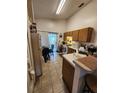 Functional kitchen with laminate countertops, tiled floors and a breakfast nook at 6434 Tidewave St, Orlando, FL 32822