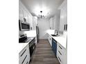 Well-lit kitchen featuring modern white cabinets, stainless steel appliances and hard surface countertops at 7147 Yacht Basin Ave # 119, Orlando, FL 32835