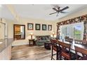Open living room with hardwood floors, cozy furniture, and a dining area overlooking the outside balcony at 7630 Heritage Crossing Way # 302, Reunion, FL 34747