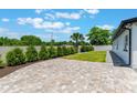 The outdoor patio offers a spacious brick-paved area with trimmed hedges and ample room for entertaining at 7664 Clubhouse Estates Dr, Orlando, FL 32819