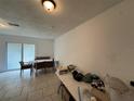 Bright dining room with sliding glass doors and tile flooring, offering ample natural light at 890 Emerald Dr, Mount Dora, FL 32757