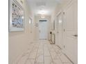Inviting hallway with neutral walls, elegant tile flooring, and ample natural light at 9034 Stinger Dr, Davenport, FL 33896