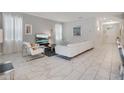 Bright living room features tile floors, modern decor, and comfortable seating arrangement at 9034 Stinger Dr, Davenport, FL 33896