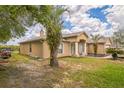 View of the house highlighting the chimney, stucco exterior, covered entry and green lawn at 10585 Sw 38Th Ave, Ocala, FL 34476