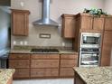 Kitchen featuring granite countertops, stainless steel appliances, and an electric stove top with stainless steel vent hood at 11120 Se 168Th Loop, Summerfield, FL 34491