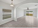 Open-concept living room featuring tiled floors and glass doors that lead to the backyard at 1123 Hacienda Cir, Kissimmee, FL 34741