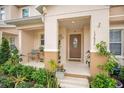 Inviting covered front porch with decorative plants and seating area at 13622 Cygnus Dr, Orlando, FL 32828