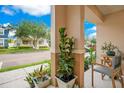 Cozy front porch featuring stylish seating and potted plants, offering a relaxing outdoor space at 13622 Cygnus Dr, Orlando, FL 32828
